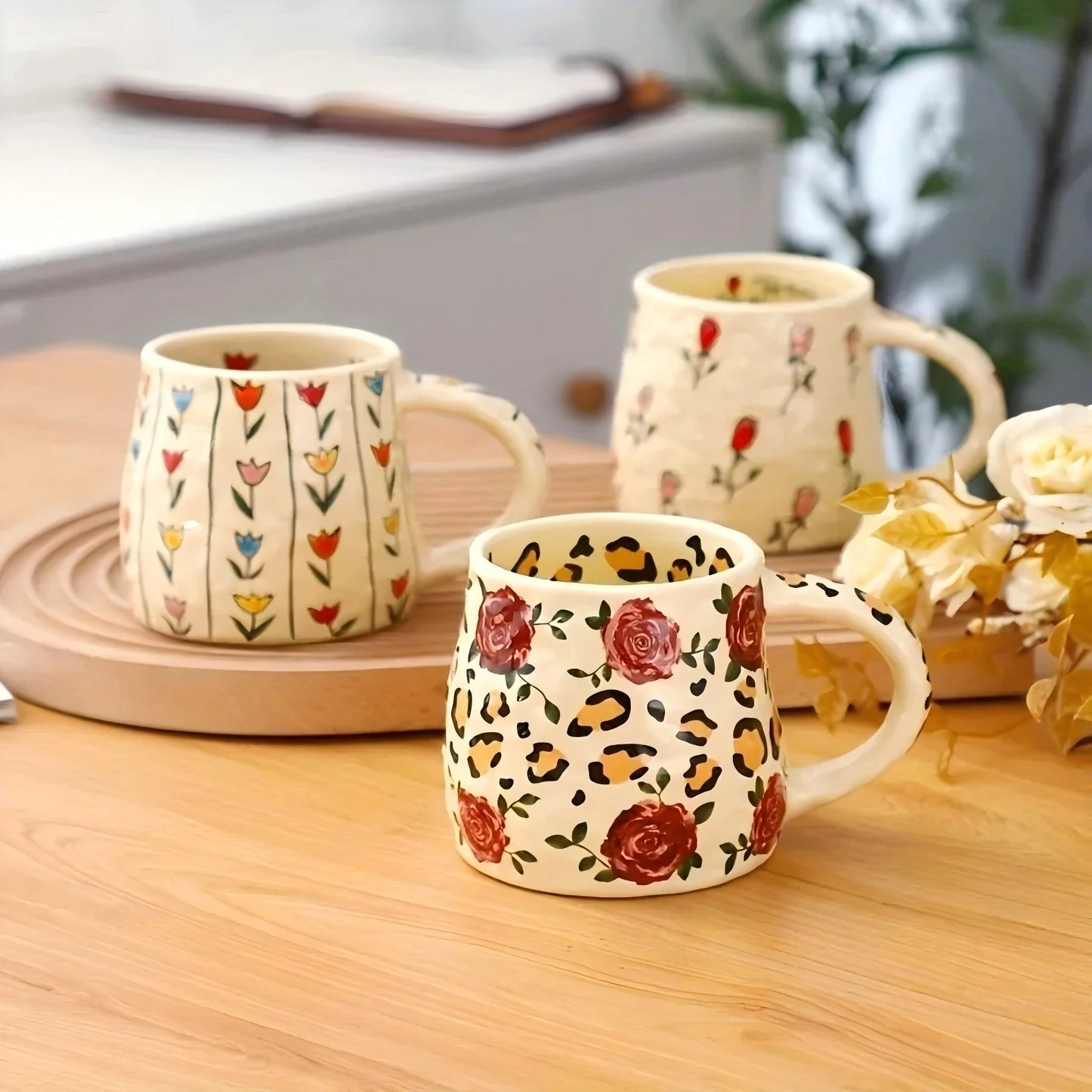 Handmade floral ceramic mug featuring colourful botanical patterns, available in tulip, rose, and vertical flower designs with a 350ml capacity.