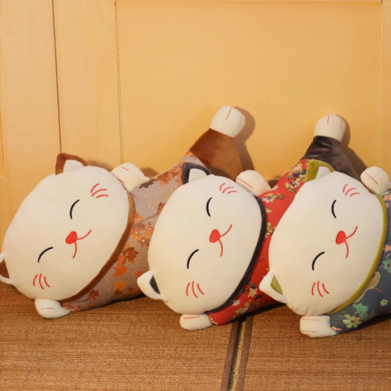 Japanese-inspired reclining cat cushion with a soft floral patterned body, shown in a selection of colourful designs 