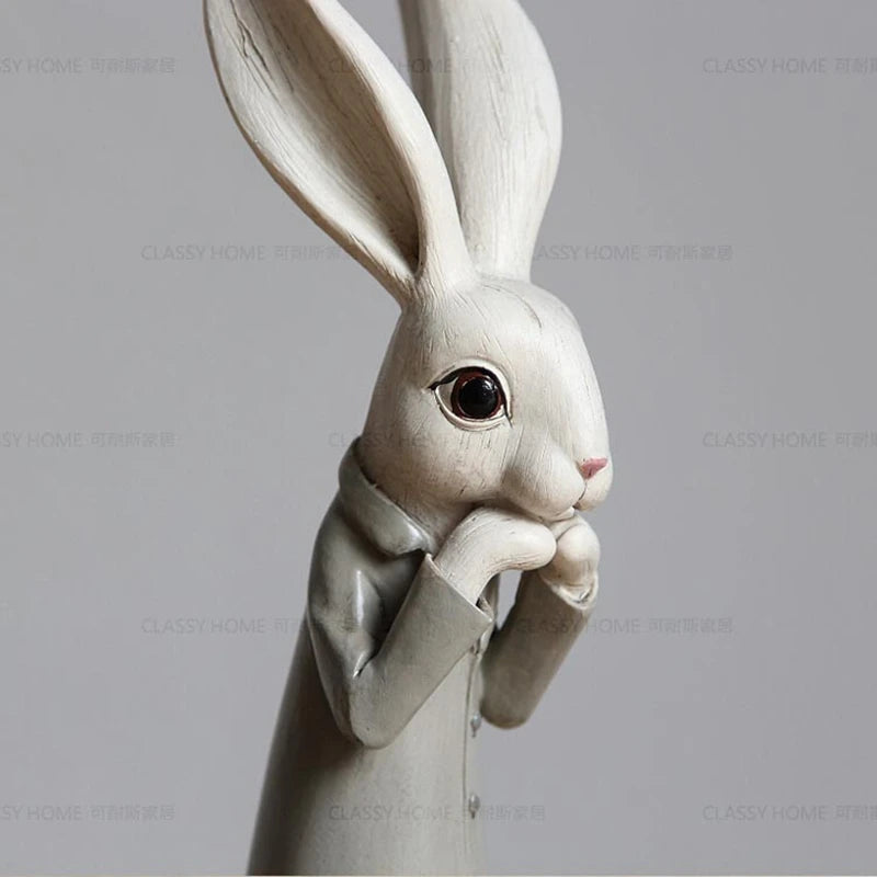 White rabbit figurine with a suit on a gray background