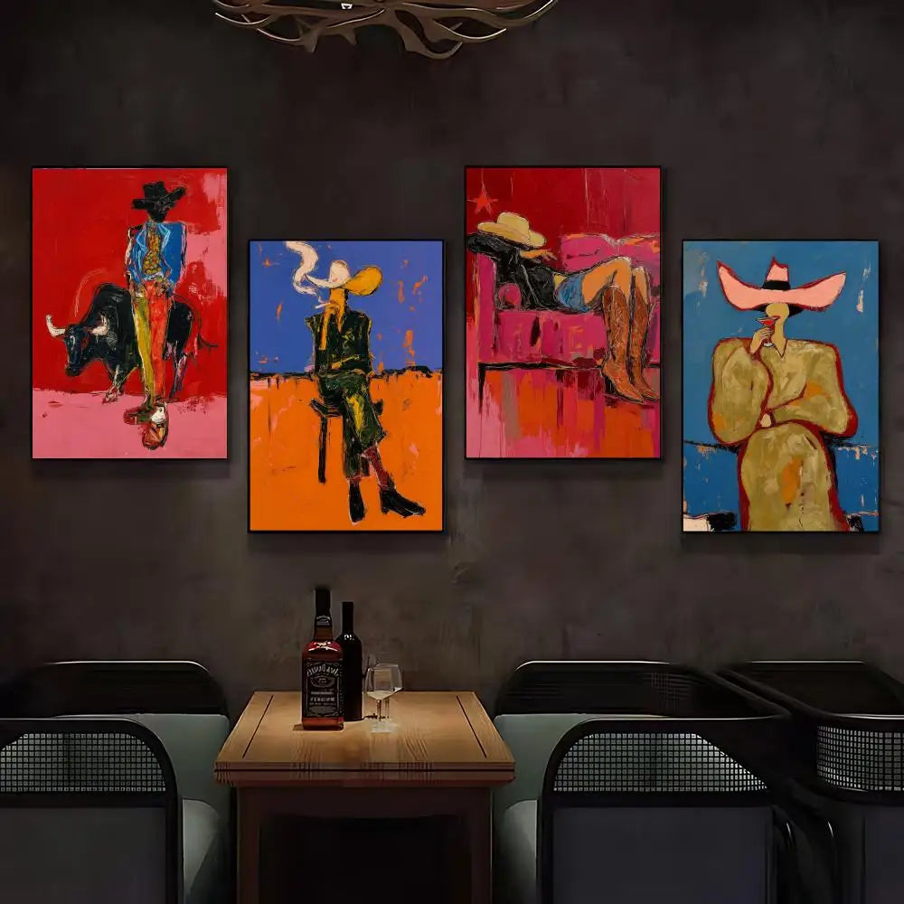 A set of four colorful abstract cowboy-themed canvas prints hangs on a dark gray wall above a wooden table with bottles and glasses in a dimly lit modern room.