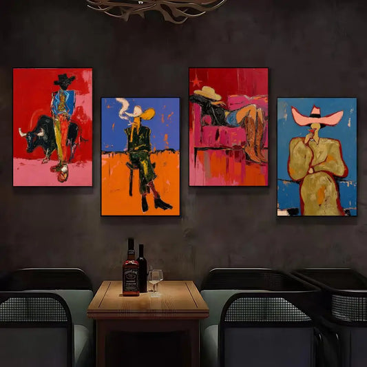 A set of four colorful abstract cowboy-themed canvas prints hangs on a dark gray wall above a wooden table with bottles and glasses in a dimly lit modern room.