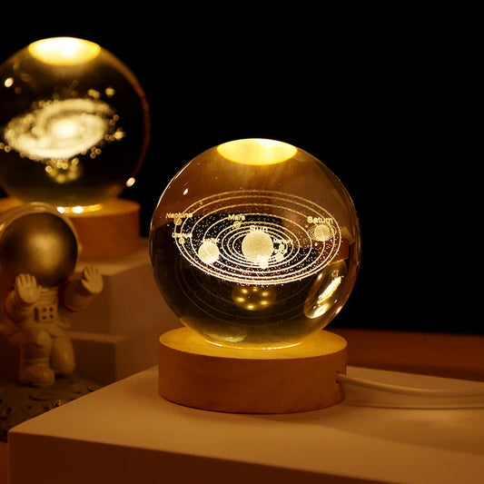 3D laser-engraved crystal ball on wooden LED base displaying the Solar System design.