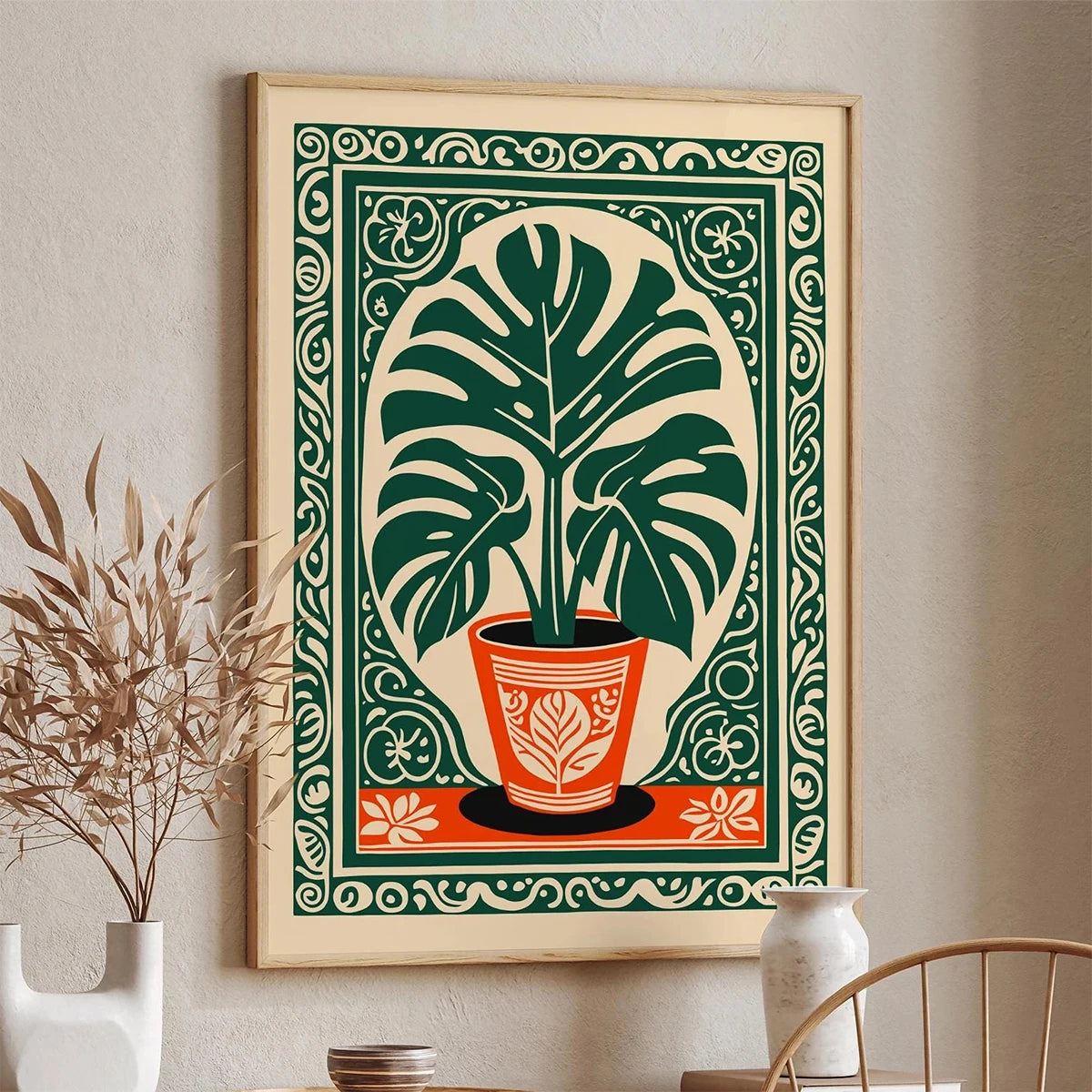 Decorative wall art with a plant design in a frame on a wall.