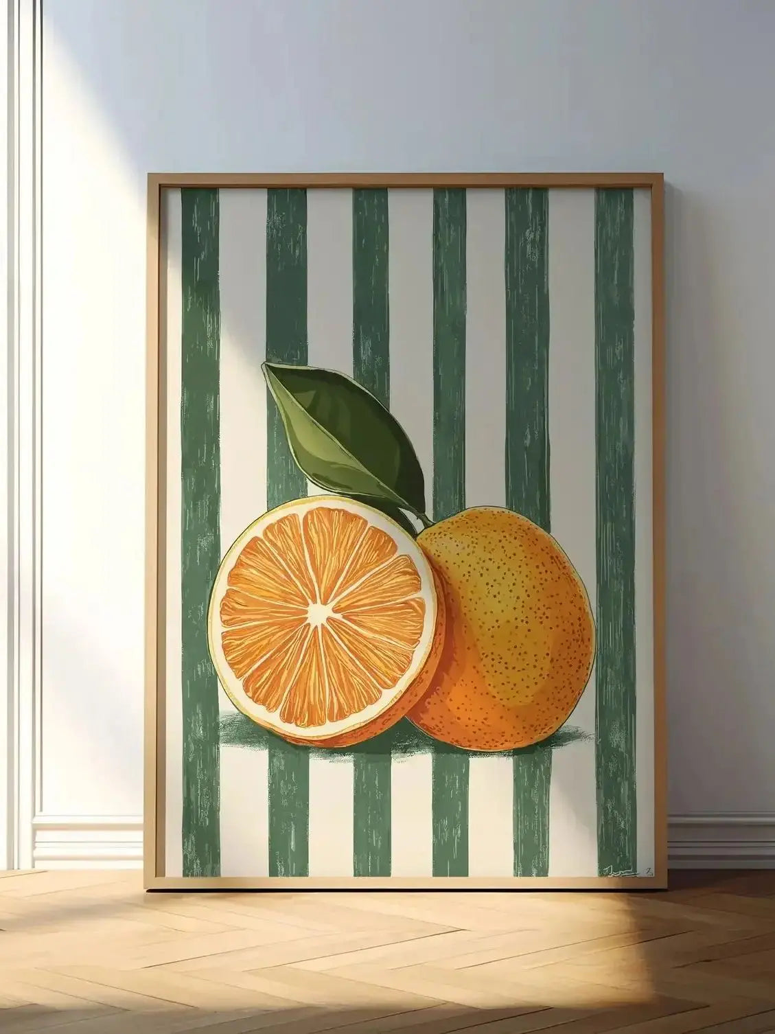 Framed artwork of oranges on a striped background