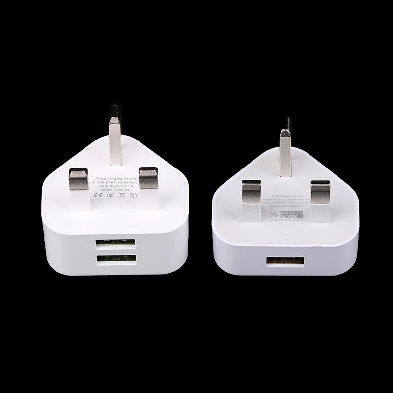 Two white travel adapters with multiple ports on a black background