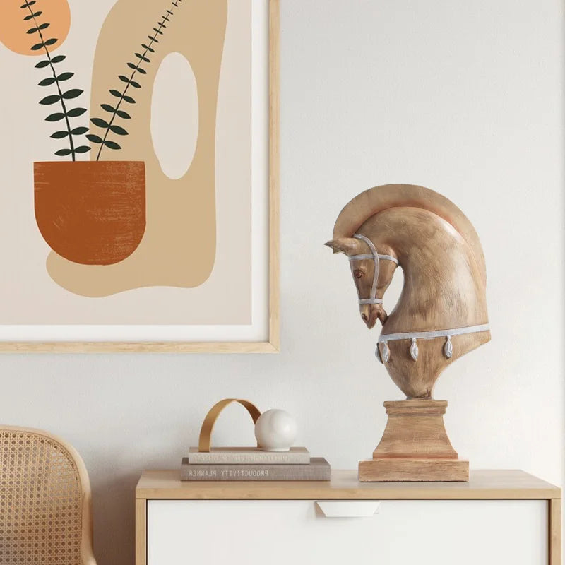 Decorative horse head sculpture on a shelf with abstract art in the background