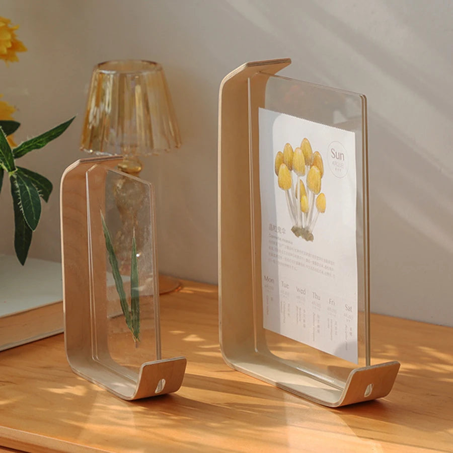 acrylic wooden photo frame displaying print on curved wooden base, displayed on a wooden table