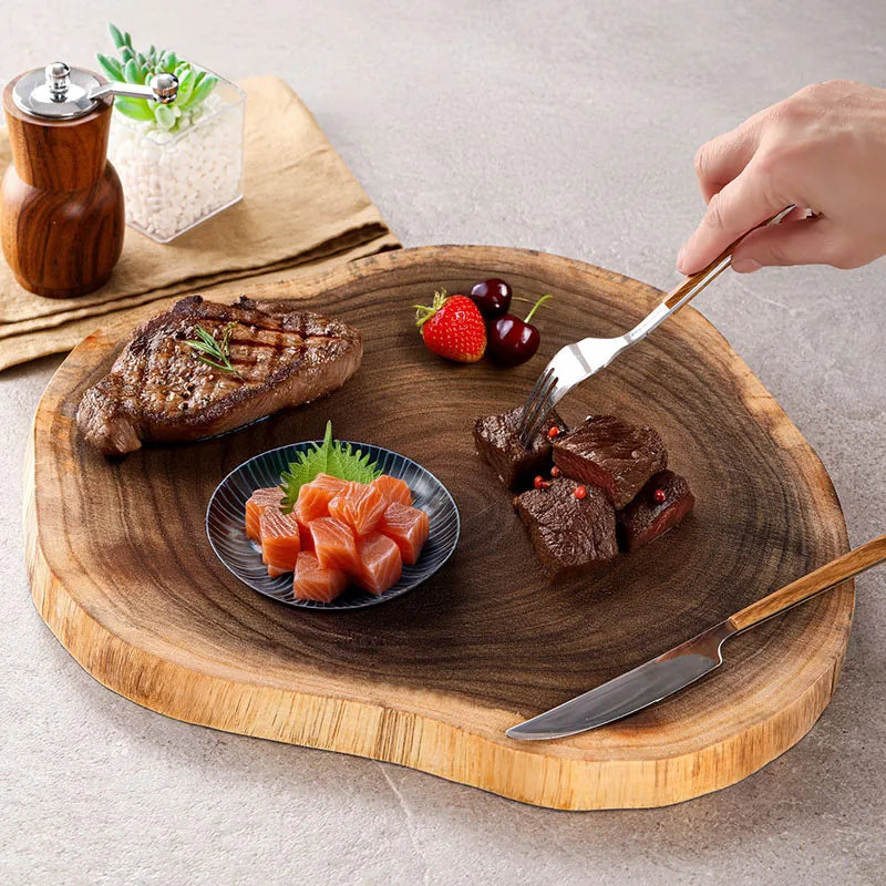 Handmade acacia wood serving tray with irregular natural shape used for steak and appetisers