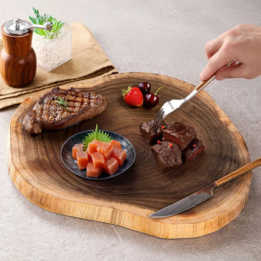 Handmade acacia wood serving tray with irregular natural shape used for steak and appetisers