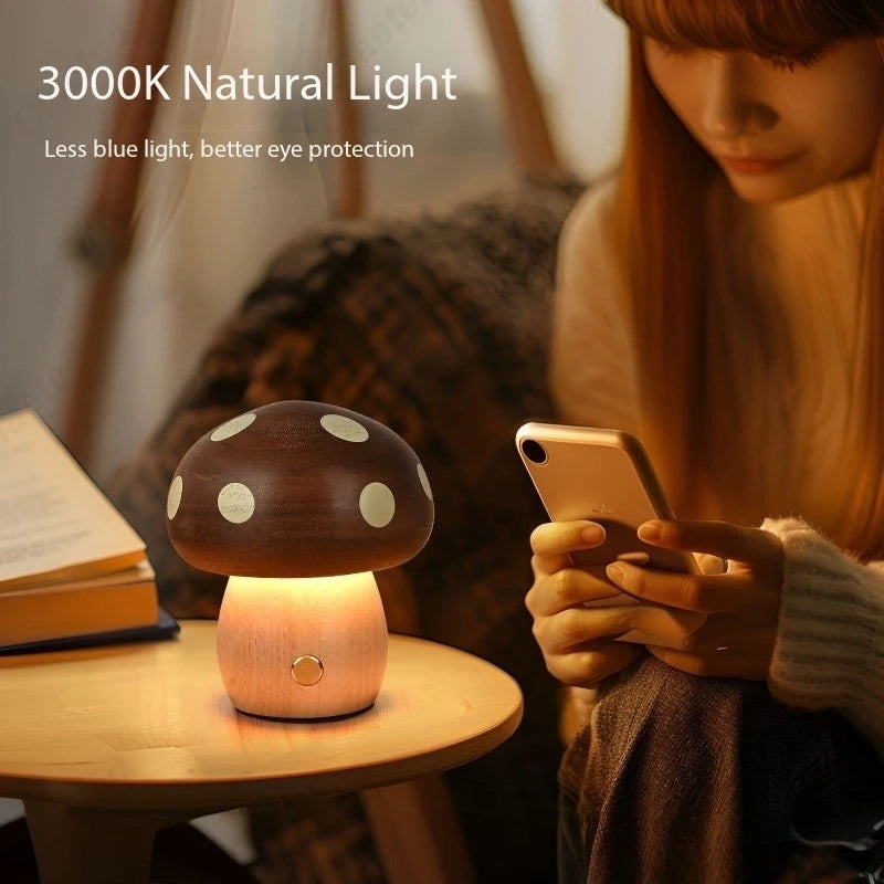 Mushroom-shaped night light on a table with a person using a phone in the background