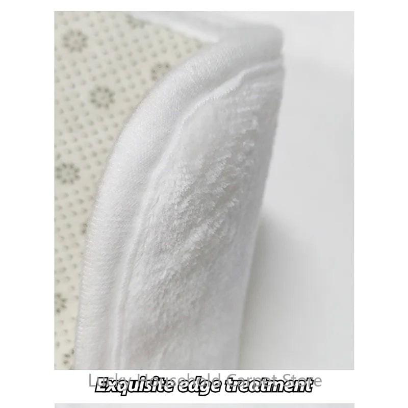 Close-up of white fabric with an exquisite edge treatment on a neutral background.