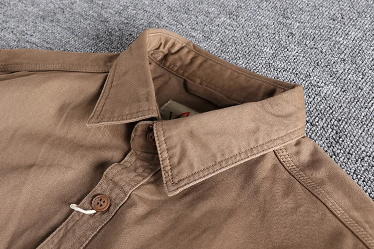 Close-up of a brown jacket collar on a textured gray background