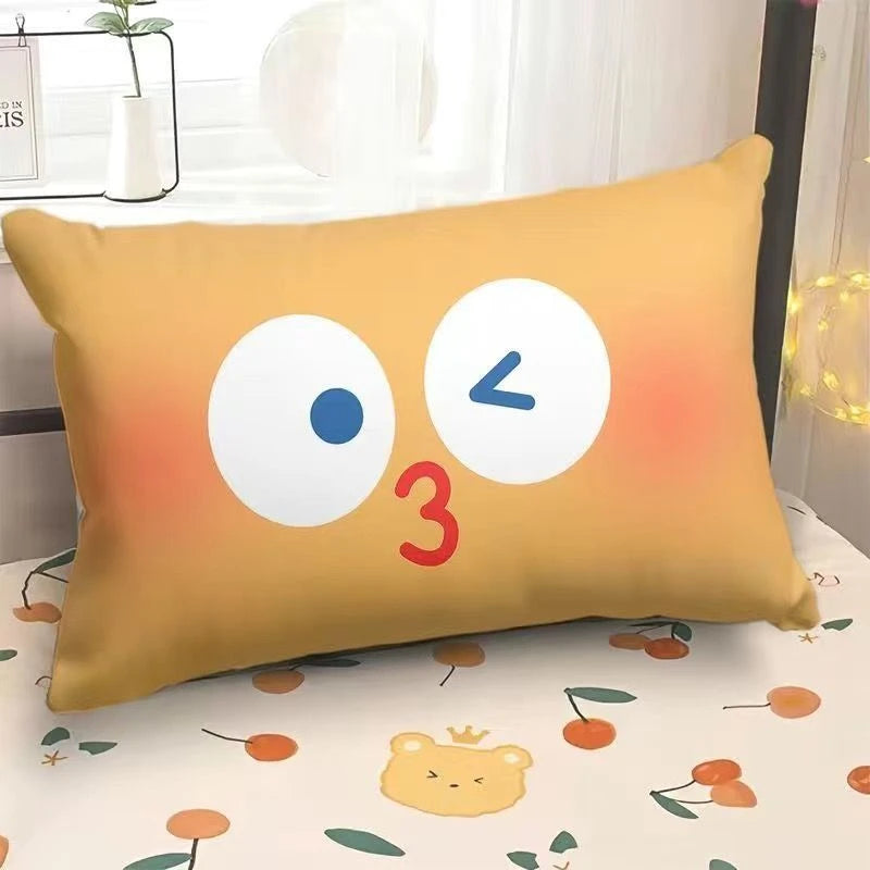 Yellow pillow with cartoon face on a bed with a floral pattern