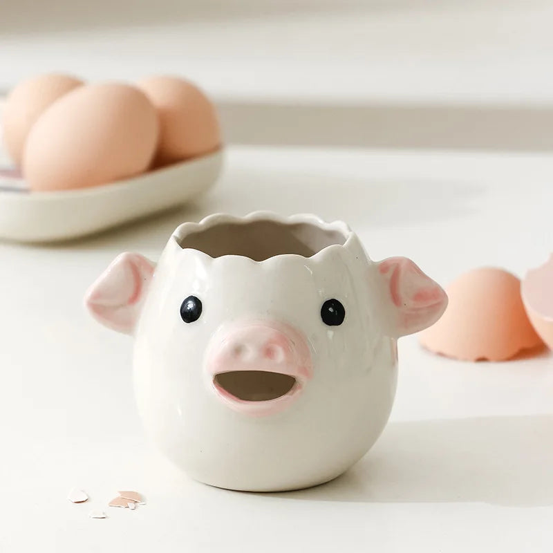 Ceramic pig-shaped container on a light surface with eggs in the background