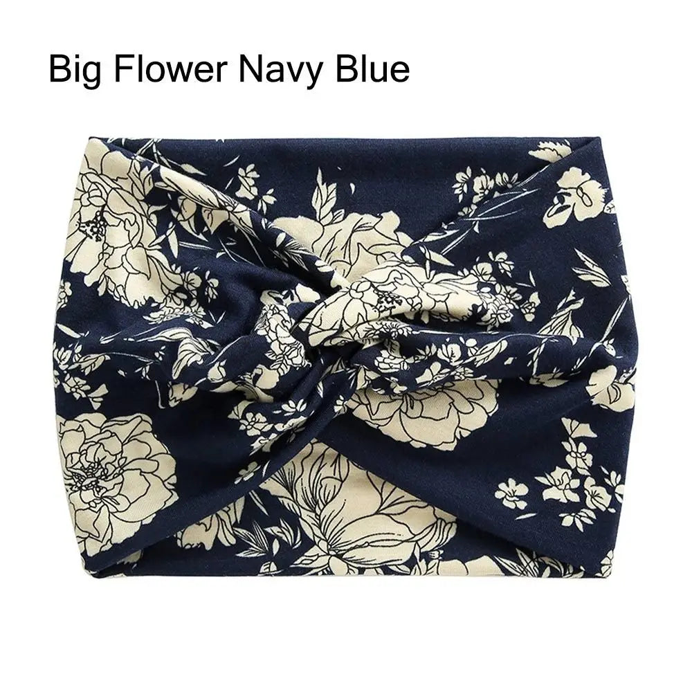 Navy blue headband with beige floral pattern on a white background