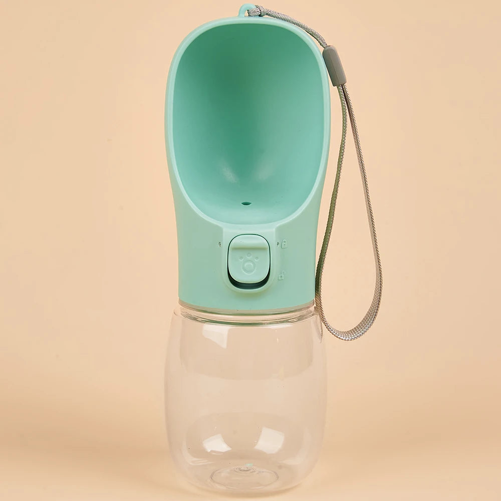 Pet water bottle with green top and clear base on a beige background