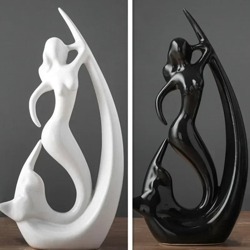 White and black abstract sculpture on a wooden surface with a gray background