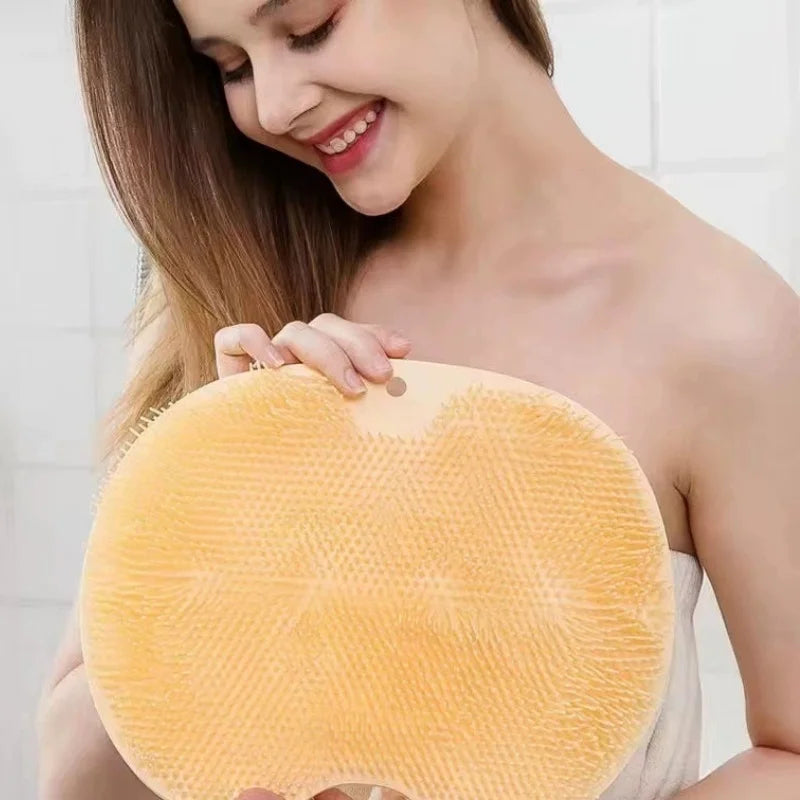 Woman holding a yellow bath sponge against a white background
