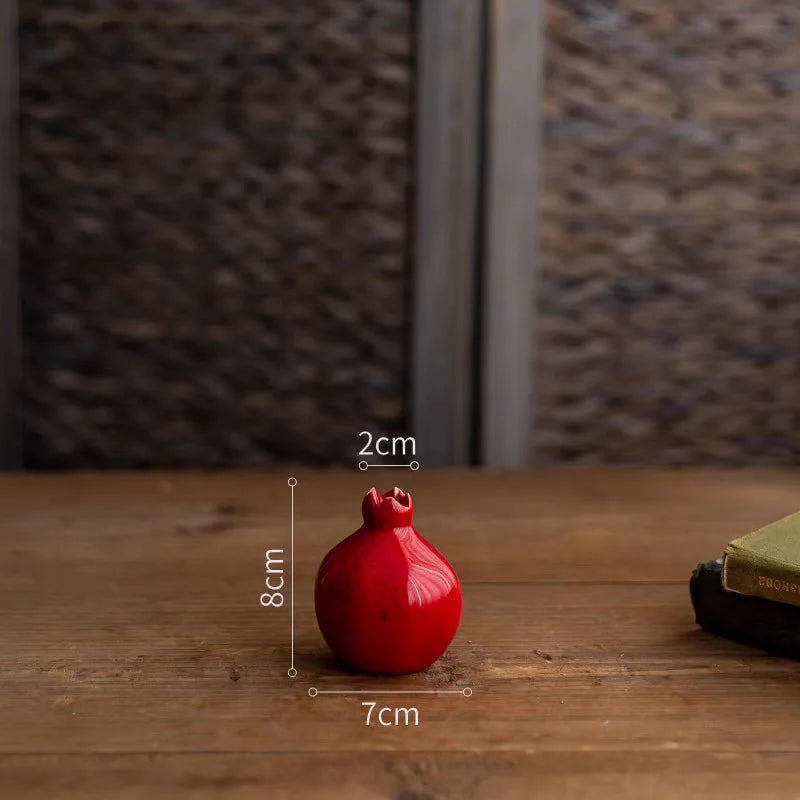 Red decorative item on a wooden surface with measurements indicated