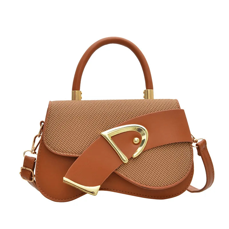 Brown handbag with gold accents on a white background