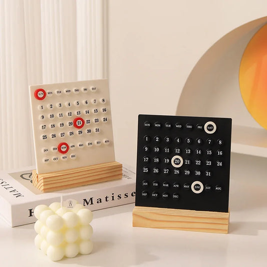 Modern perpetual desk calendar with wooden base, available in square and arch designs in black or white, minimalist desktop decor for home office and study spaces.