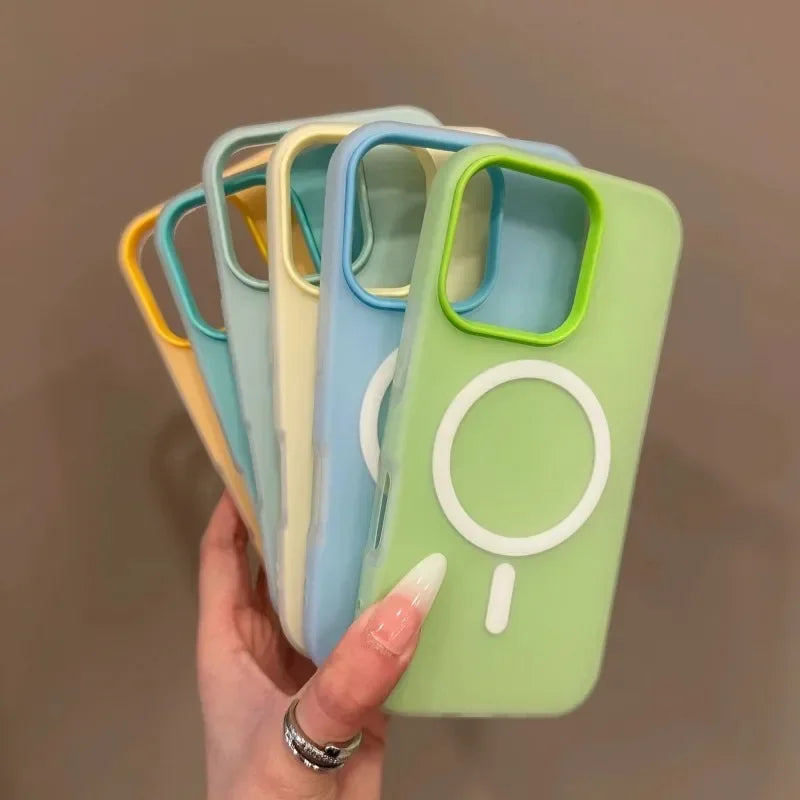 Set of colorful phone cases with a hand holding one green case.
