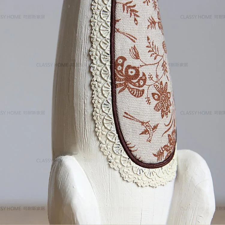 Decorative headband with floral lace on a mannequin head against a plain background