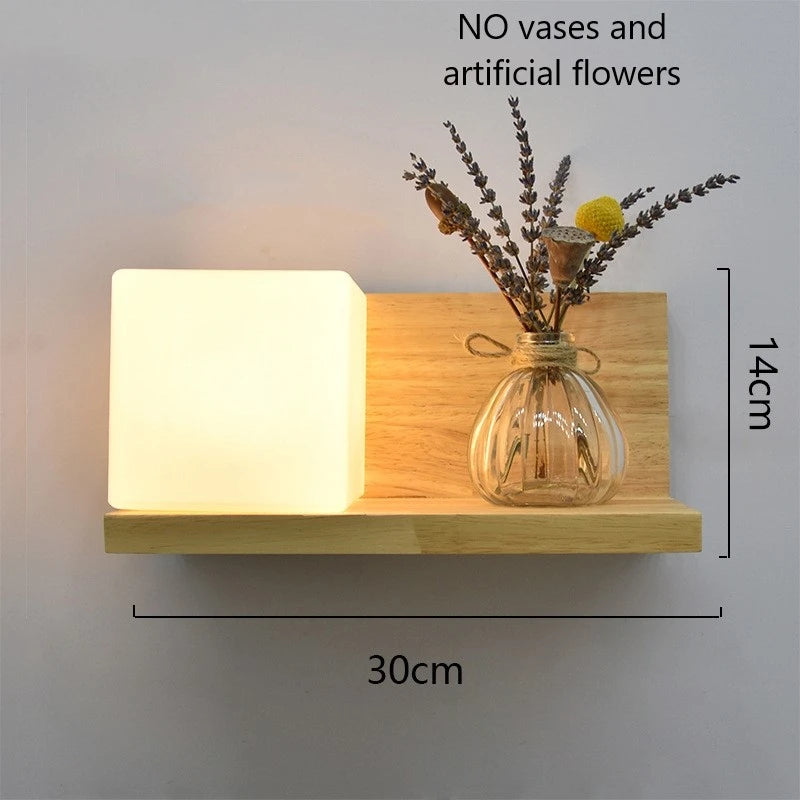 Wooden wall shelf with a glass vase containing dried flowers, dimensions indicated.