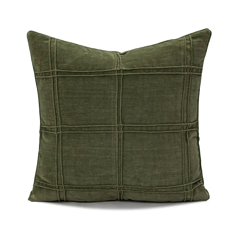 Green pillow with grid pattern on a white background