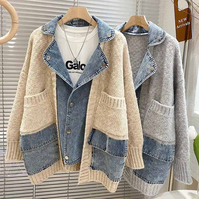 Two cardigans with denim accents on hangers against a neutral background