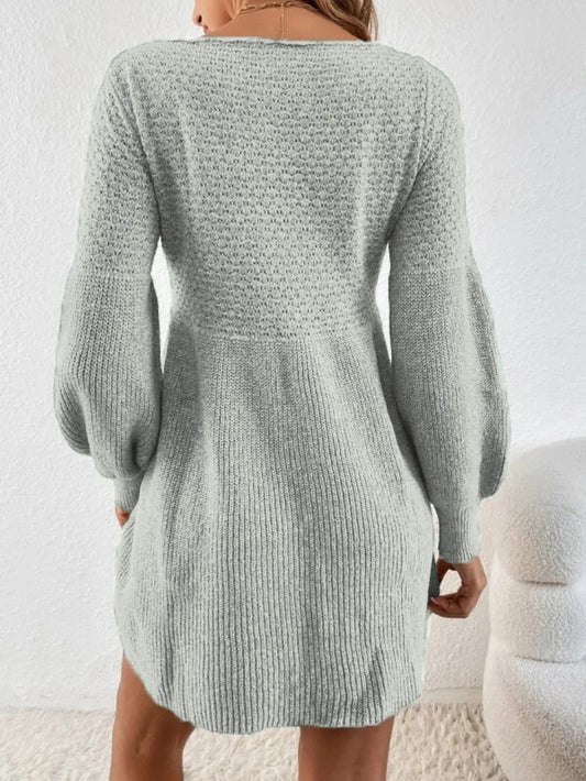 Light gray knitted dress worn by a person on a white background