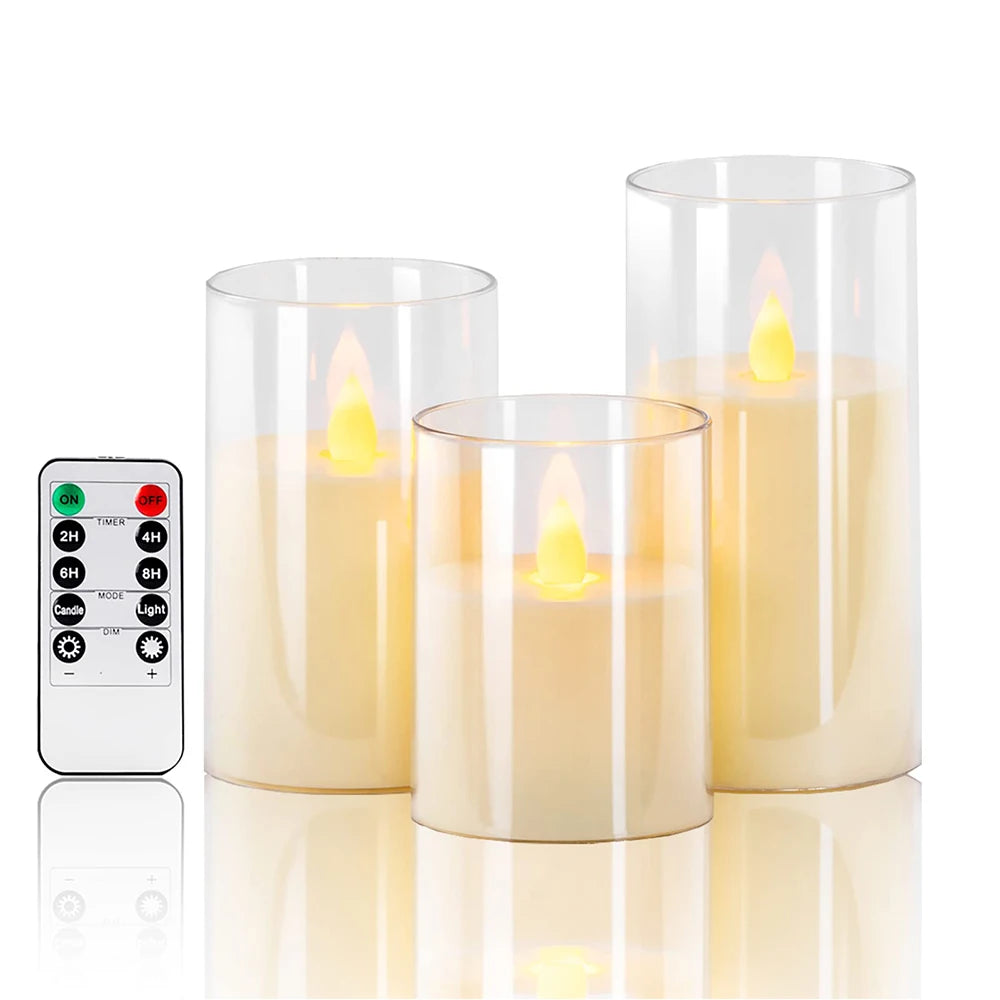 Set of three flameless candles with a remote control on a white background