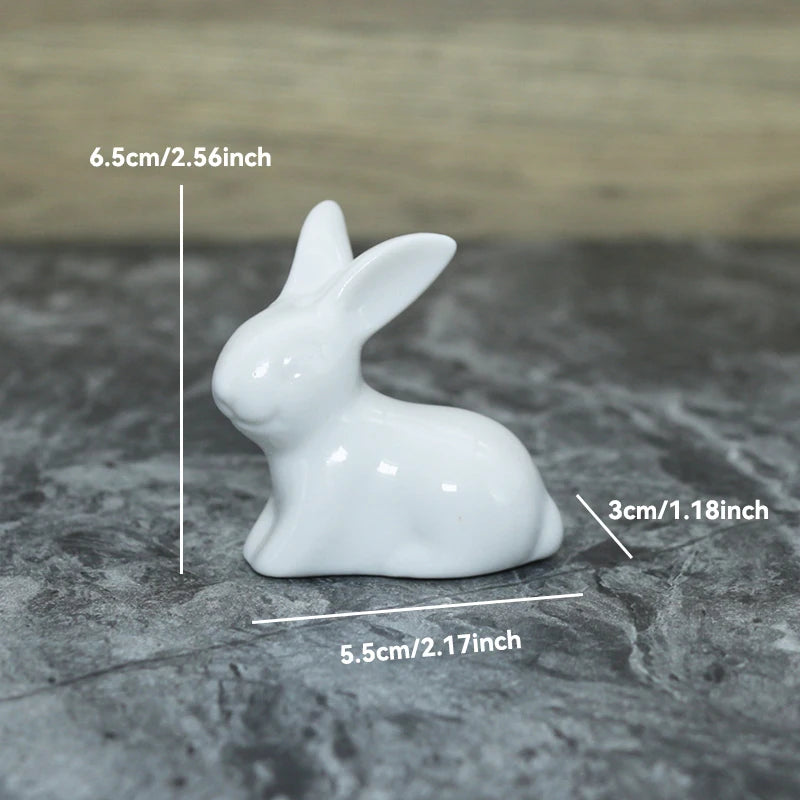 White ceramic rabbit figurine with measurements on a gray surface
