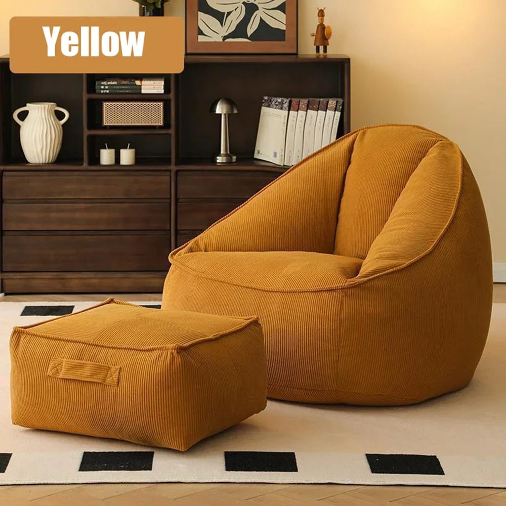 Yellow bean bag chair and ottoman in a living room setting with a bookshelf in the background.
