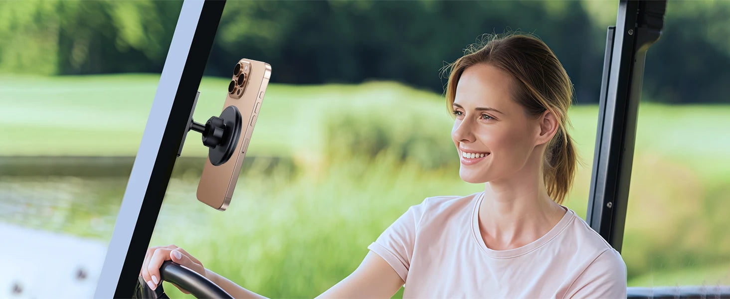 Woman sitting in a golf cart with a phone mount on the dashboard, surrounded by greenery.