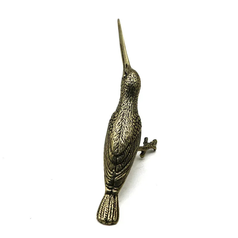Bronze bird figurine on a white background