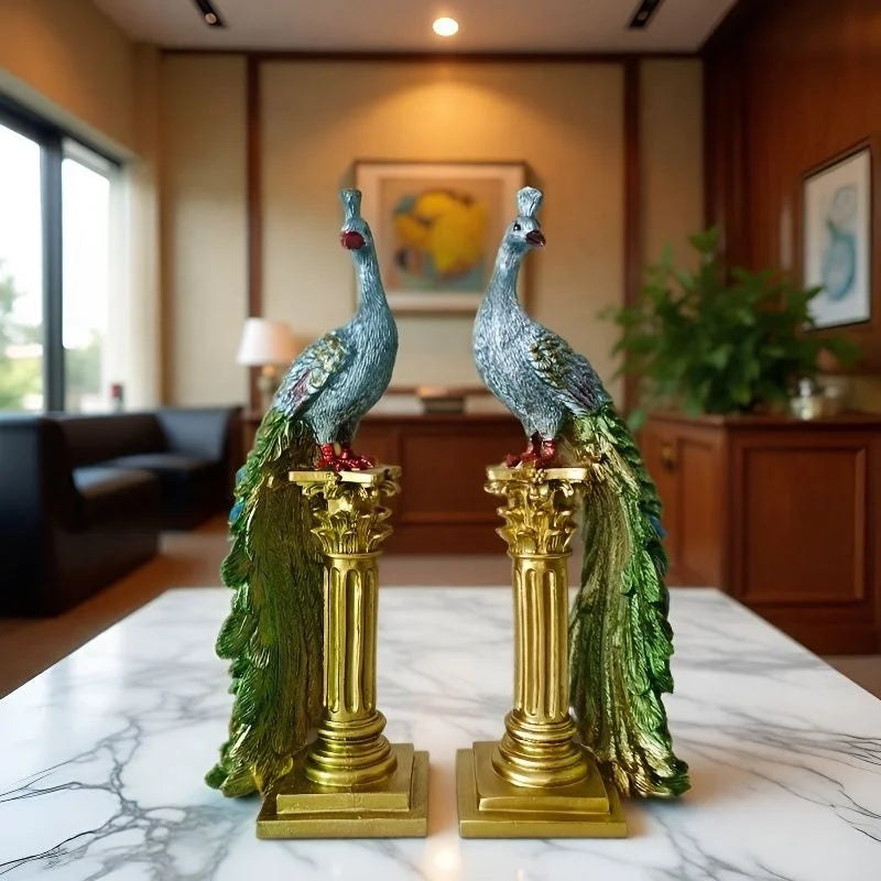 Two decorative peacock statues on gold pedestals in a room with furniture and decor.