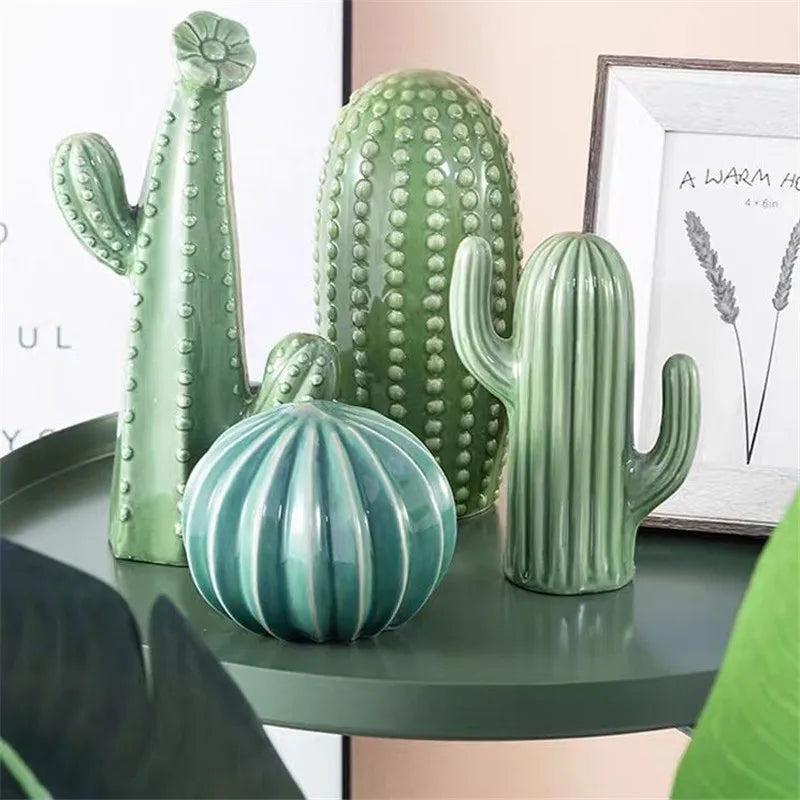 Set of green ceramic cacti on a table with a blurred background