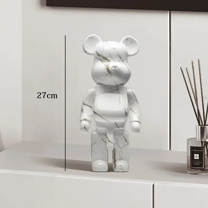 Marble-patterned bear figure on a white surface with a diffuser in the background
