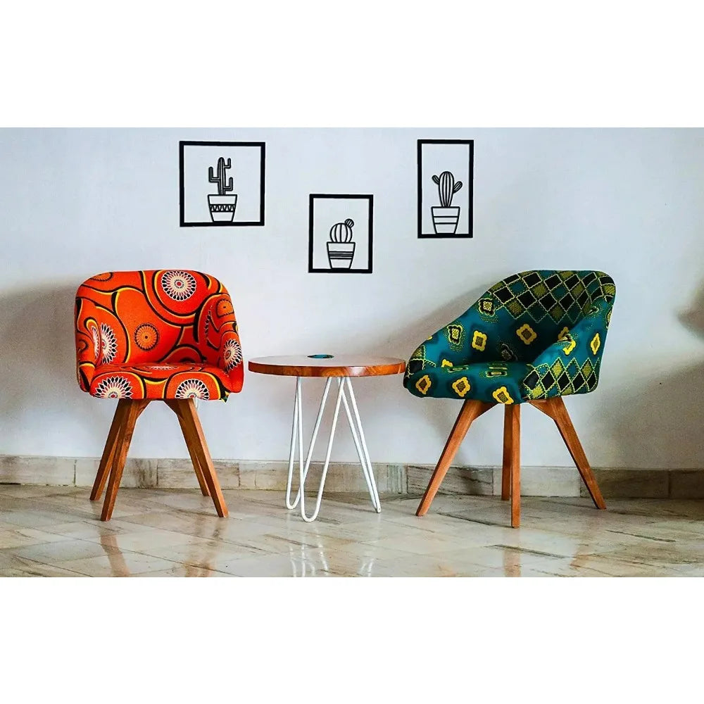 Three piece black metal cactus wall art set arranged side by side in modern minimalist style with colourful chairs and a modern table