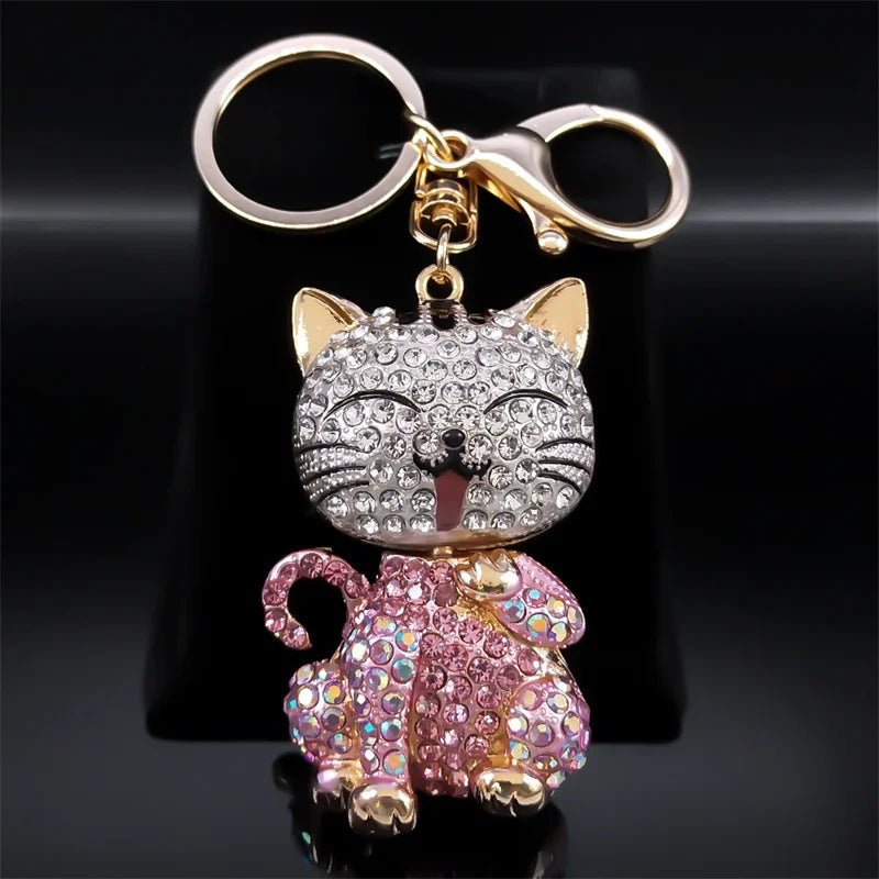 Cat-shaped keychain with rhinestones on a black background