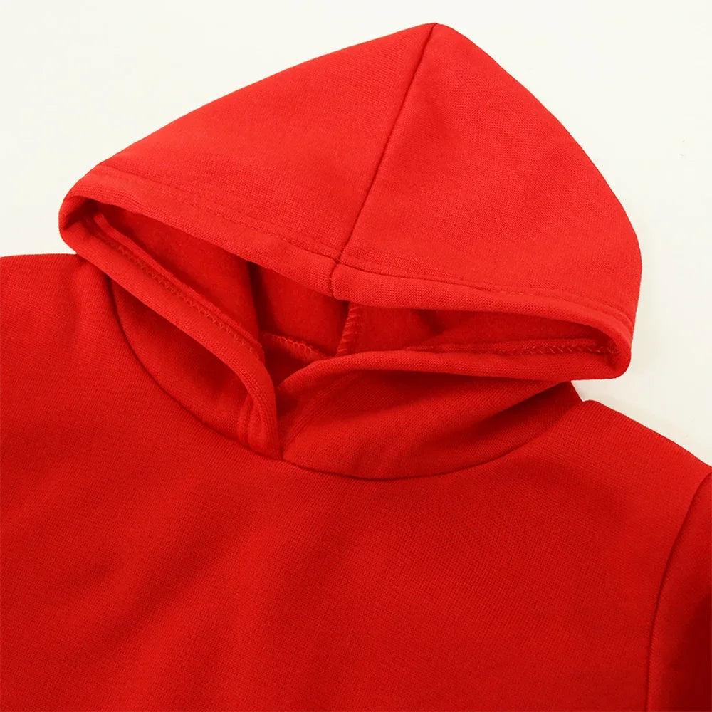 Close-up of a red hoodie with a hood on a beige background