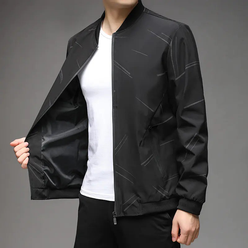 Person wearing a black jacket with white stripes on a gray background