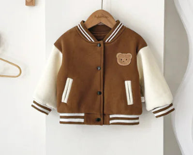 Children's brown and white varsity jacket with bear emblem on a hanger against a white background