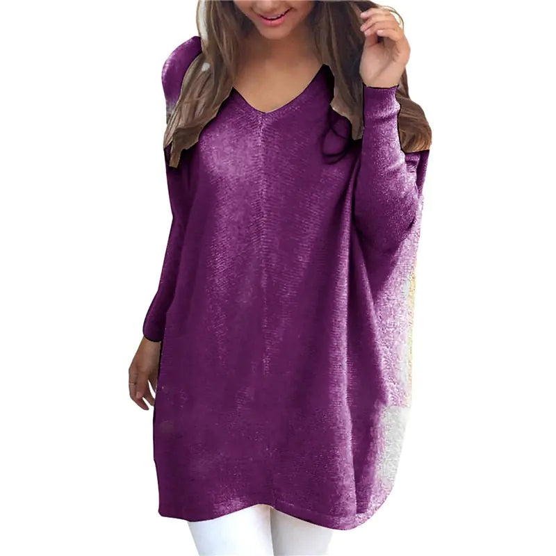 Purple long-sleeve top worn by a person on a white background