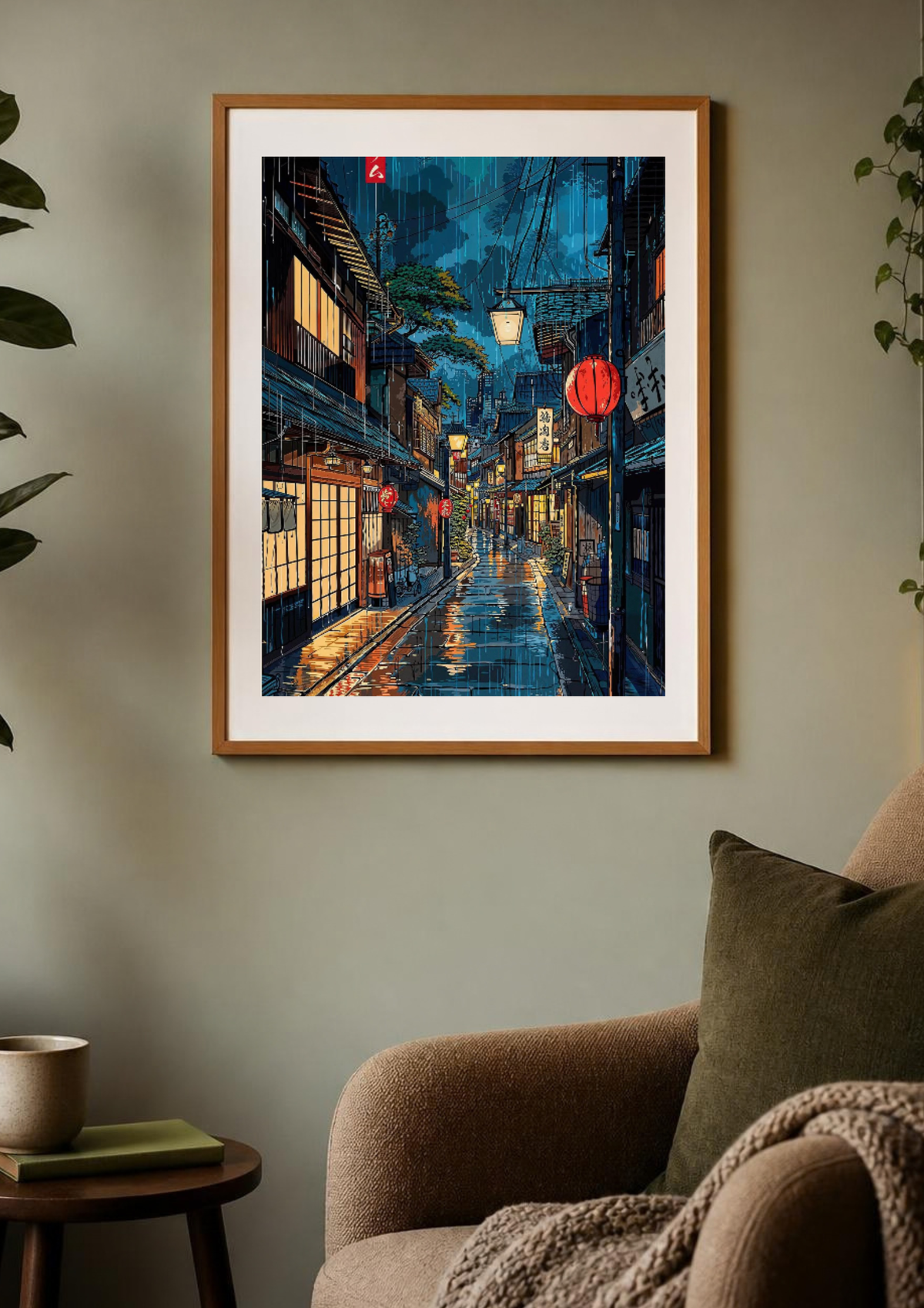 A framed art print depicting a vibrant, colorful Japanese street at night with glowing lanterns and wet reflections, styled on a beige wall above a brown armchair.