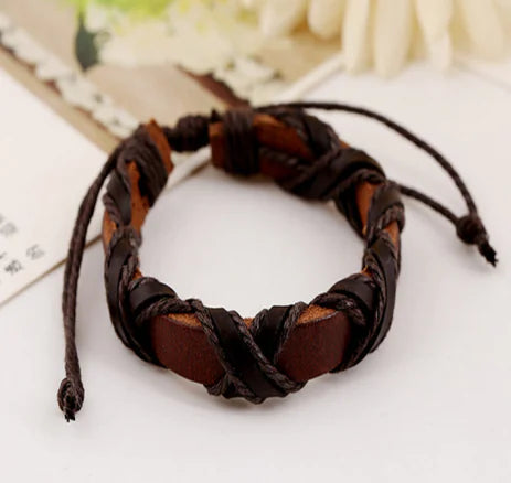 Brown braided leather bracelet on a light background