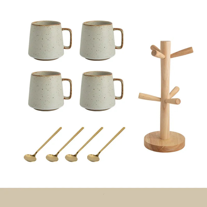 Set of four ceramic mugs, four wooden spoons, and a wooden stand on a white background