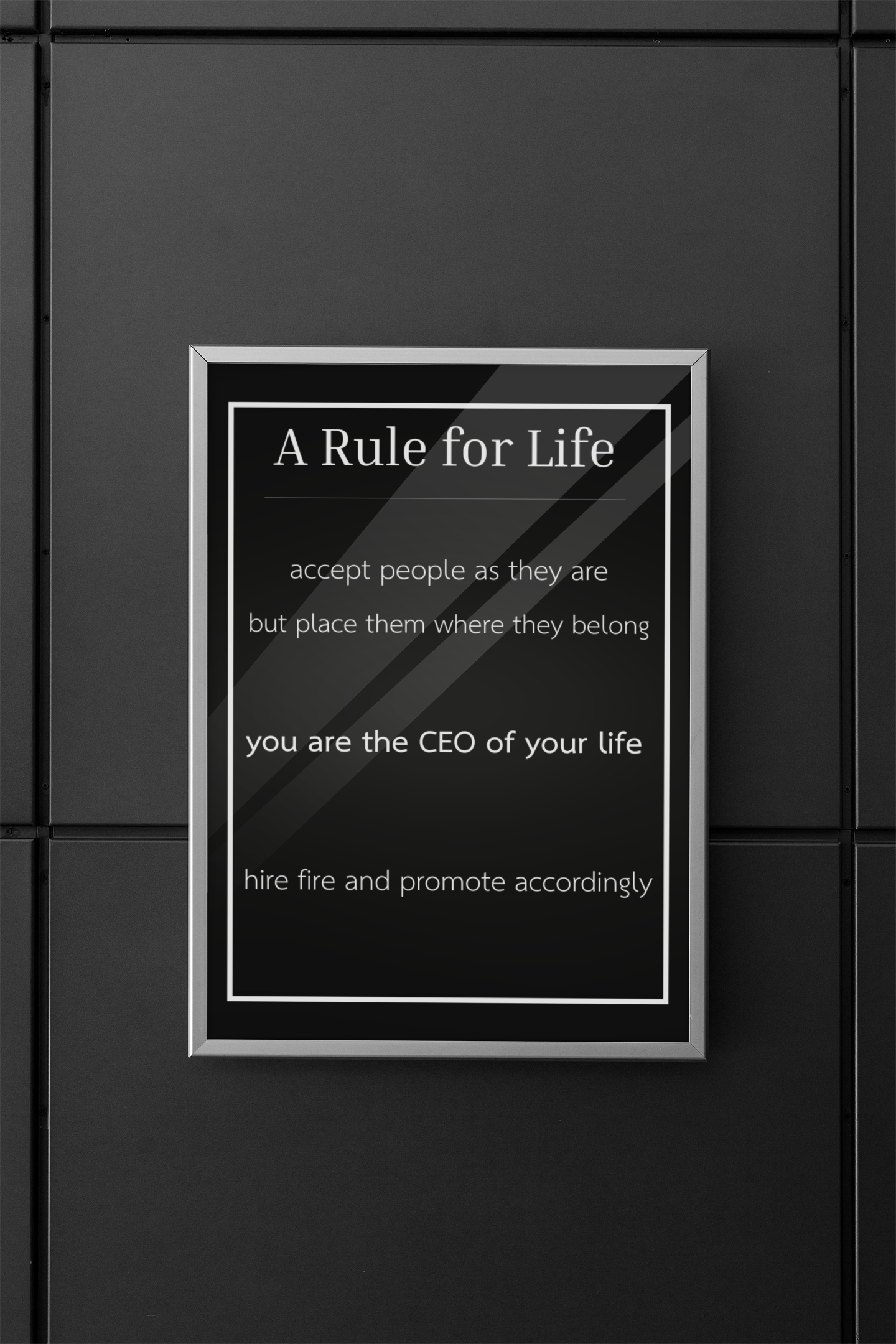 Framed quote on a black tiled wall