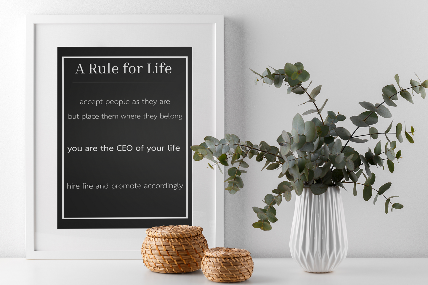 framed black quote poster styled with plant and neutral home decor